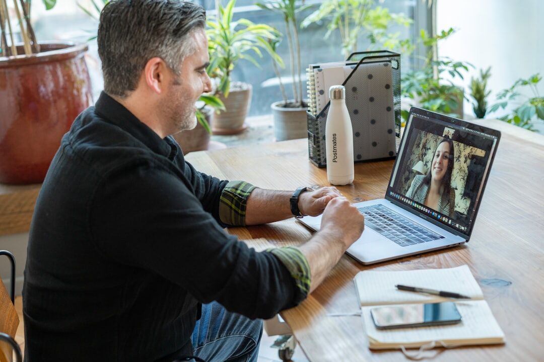 Coordinator managing remote speakers on video call during a live event