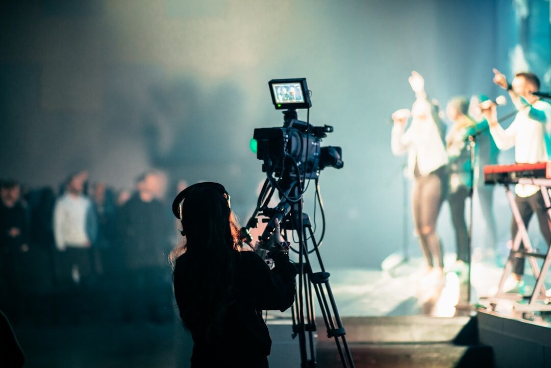 Cameraman filming a live event on stage